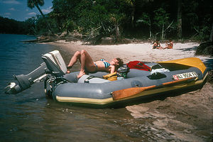 Lolo reclining on raft in Hunting Island lagoon