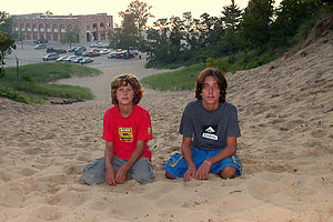 Boy's playing in the dunes overlooking the e.coli ridden lake