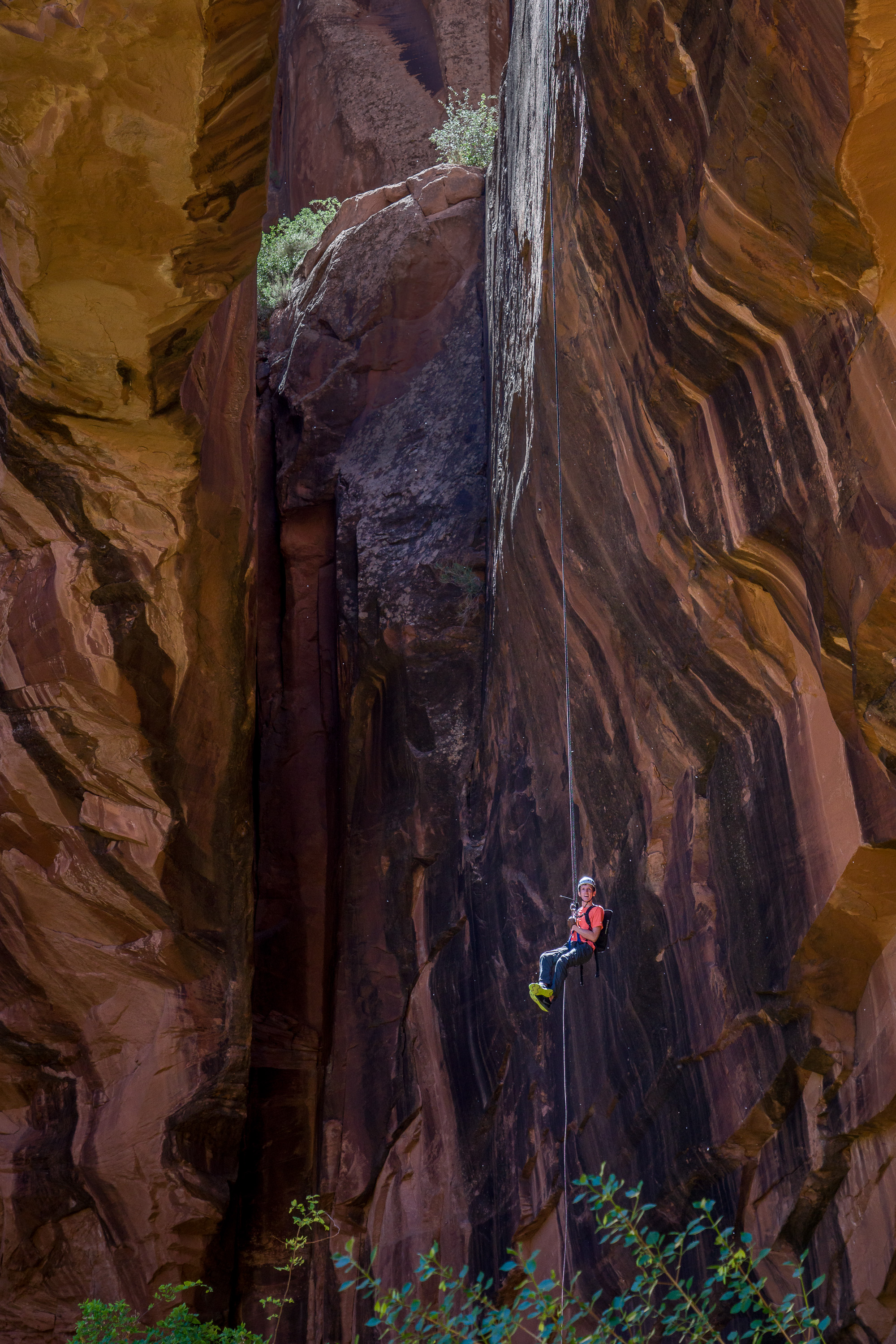 Rappeller descending from top of Morning Glory Natural Bridge