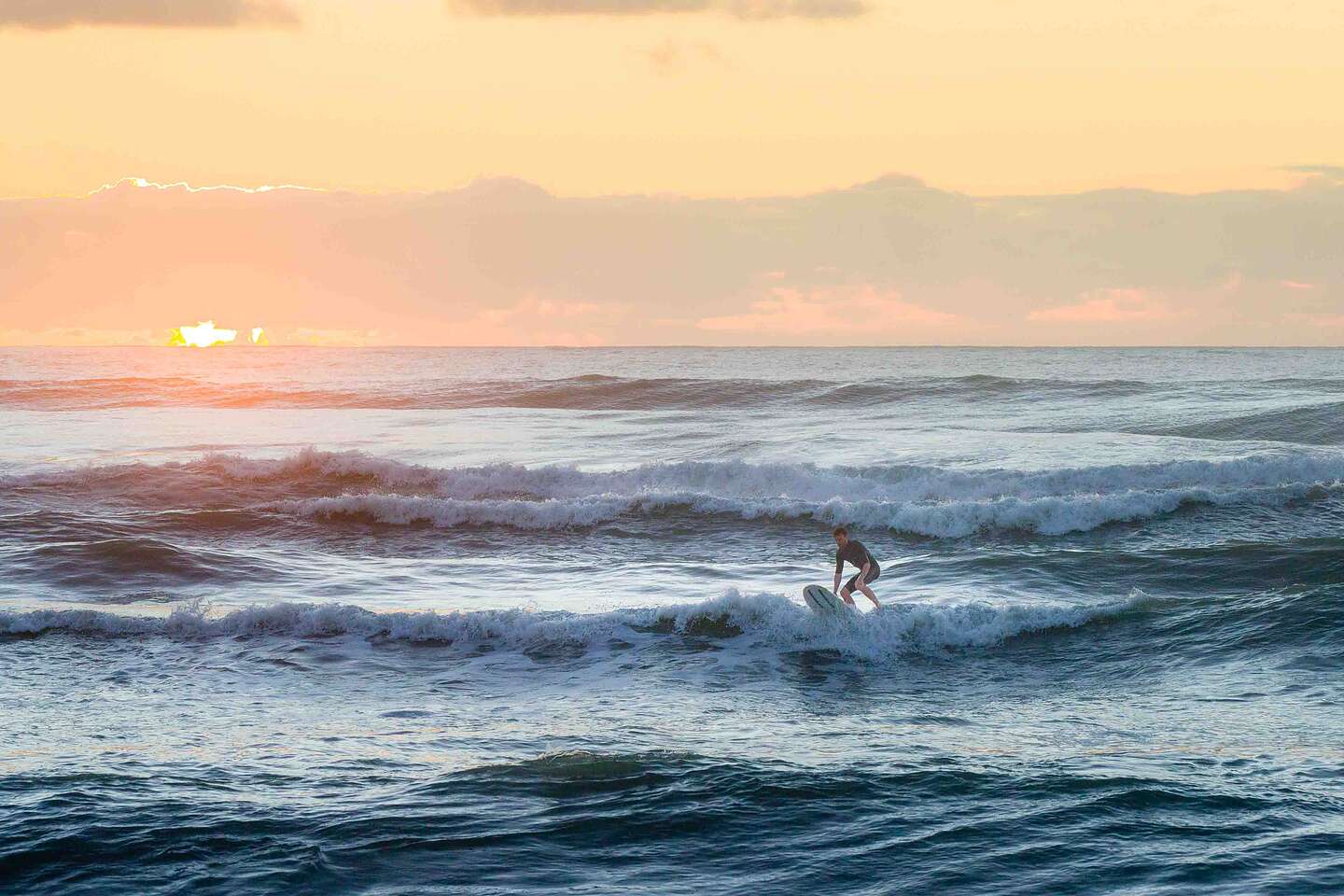 Surfer off Punakaiki Beach