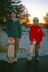 Boys post skate boarding